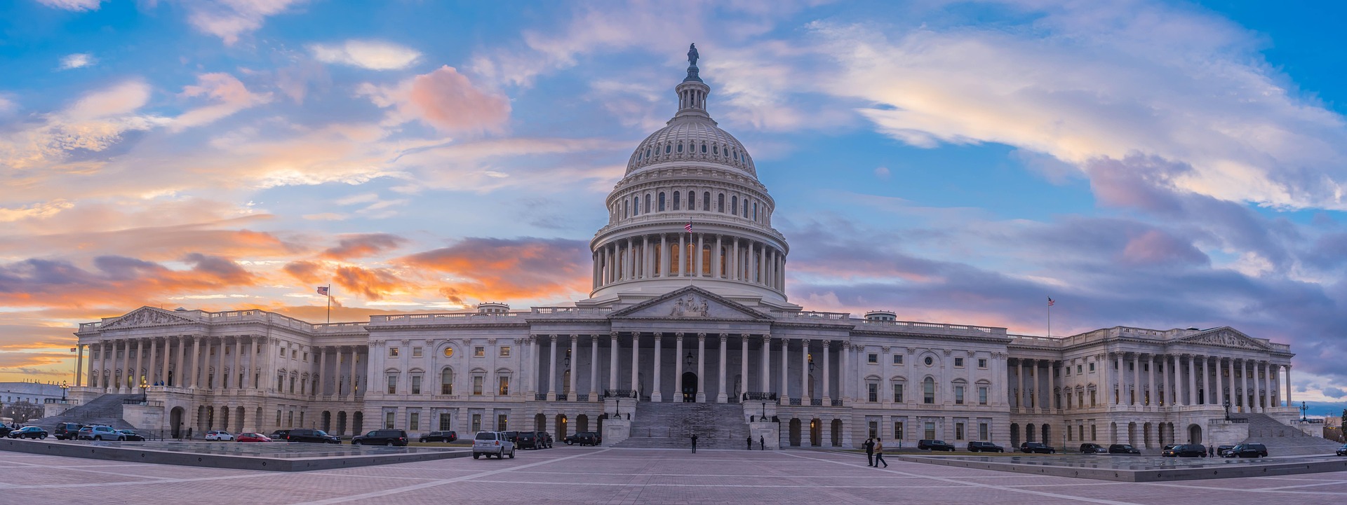 A photo of the US Capitol. The sun is setting.