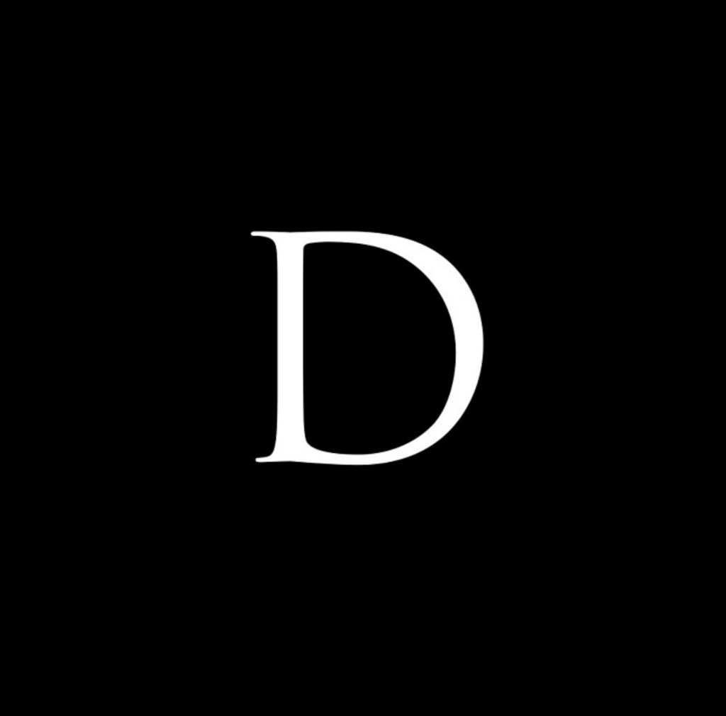 A capital letter D in white font against a black background. 