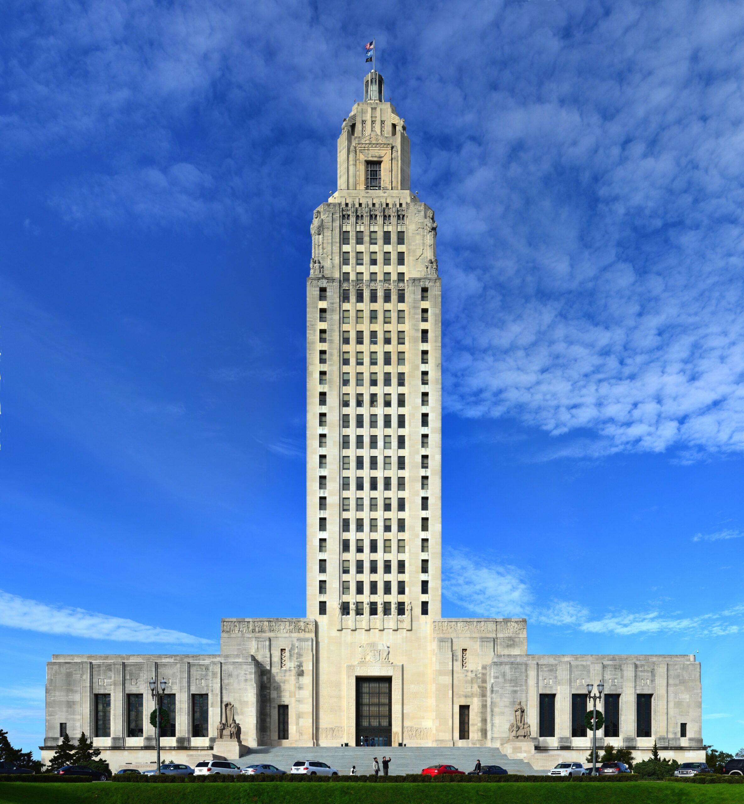Image of the Louisiana State Capitol building, which is white with a tower in the middle.