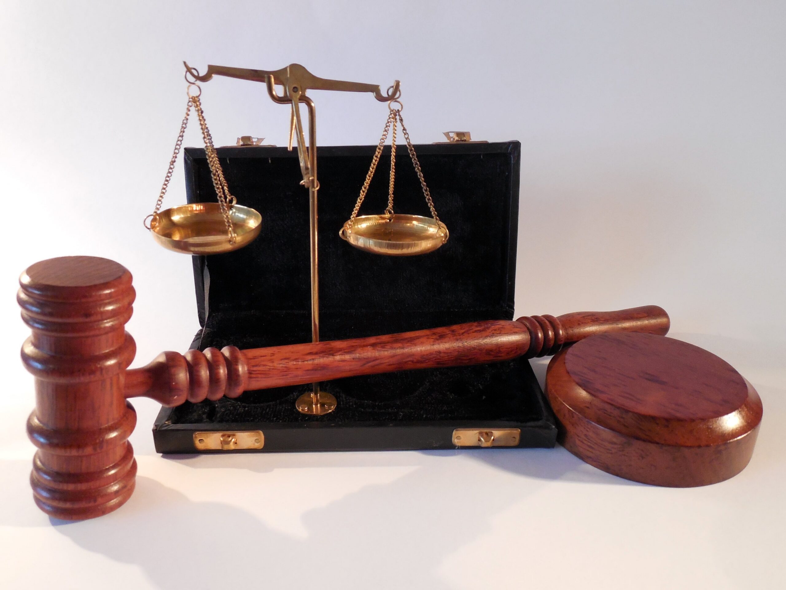 The weights of justice sit with a brief case and gable